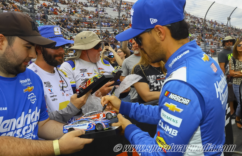 Kyle Larson signing a car for a fan.jpg