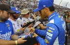 Kyle Larson signing a car for a fan
