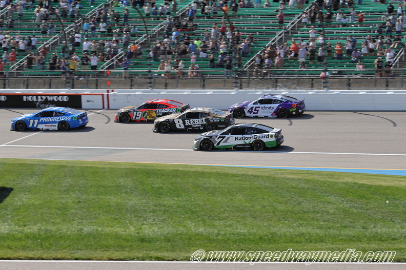 Denny Hamlin leads pack of cars out of turn 4.JPG