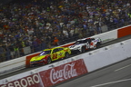 Christopher Bell on the bumper of Joey Logano