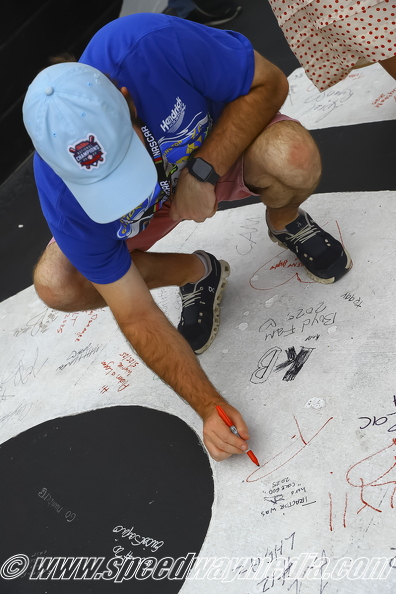 Fans signing the start finish line.jpg