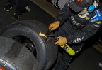 Crewman cleaning tires before measuring