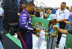 Bubba Wallace signing a young fans shirt