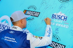 Ryan Preece signs his name to the pole winners banner