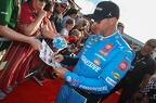 Denny Hamlin signing a fans sign