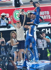 Kyle Larson celerbrates with children