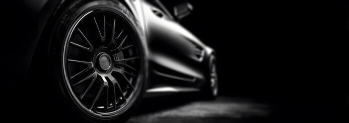 close up of side sports car wheel with alloy rim against dark background highlighting luxury automotive design power speed performance concept perfect for vehicle advertising or engineering showcase