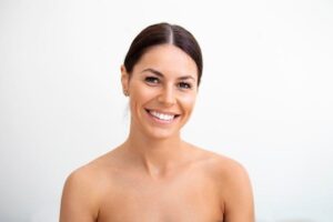 young pretty woman getting special skin treatment beautiful girl applying serum isolated on white background smooth skin without wrinkles