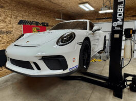 White Porsche 911 on a lift in a garage