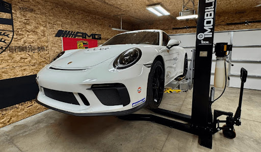 3 Proven Ways to Boost Garage Safety White Porsche 911 on a lift in a garage