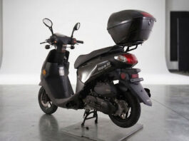 Black Vogue 50 moped with a storage trunk in studio