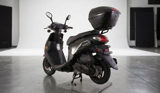 3 Top Tips for Safe Moped Racing Black Vogue 50 moped with a storage trunk in studio