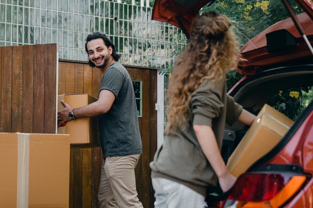 Questions to Ask Before Accepting a Job That Requires Relocation A couple with moving boxes.