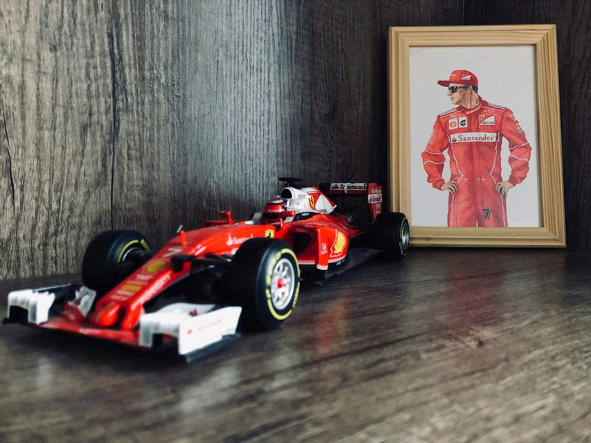 3 Surprising Hacks Elevating Racing Memorabilia Displays Red Ferrari Formula One model car next to driver portrait