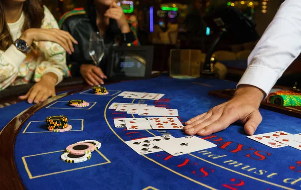 depositphotos_364349212-stock-photo-casino-poker-cards-croupier-hand